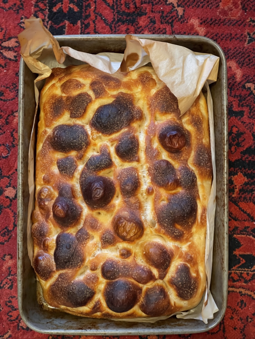 Golden focaccia in a baking tray