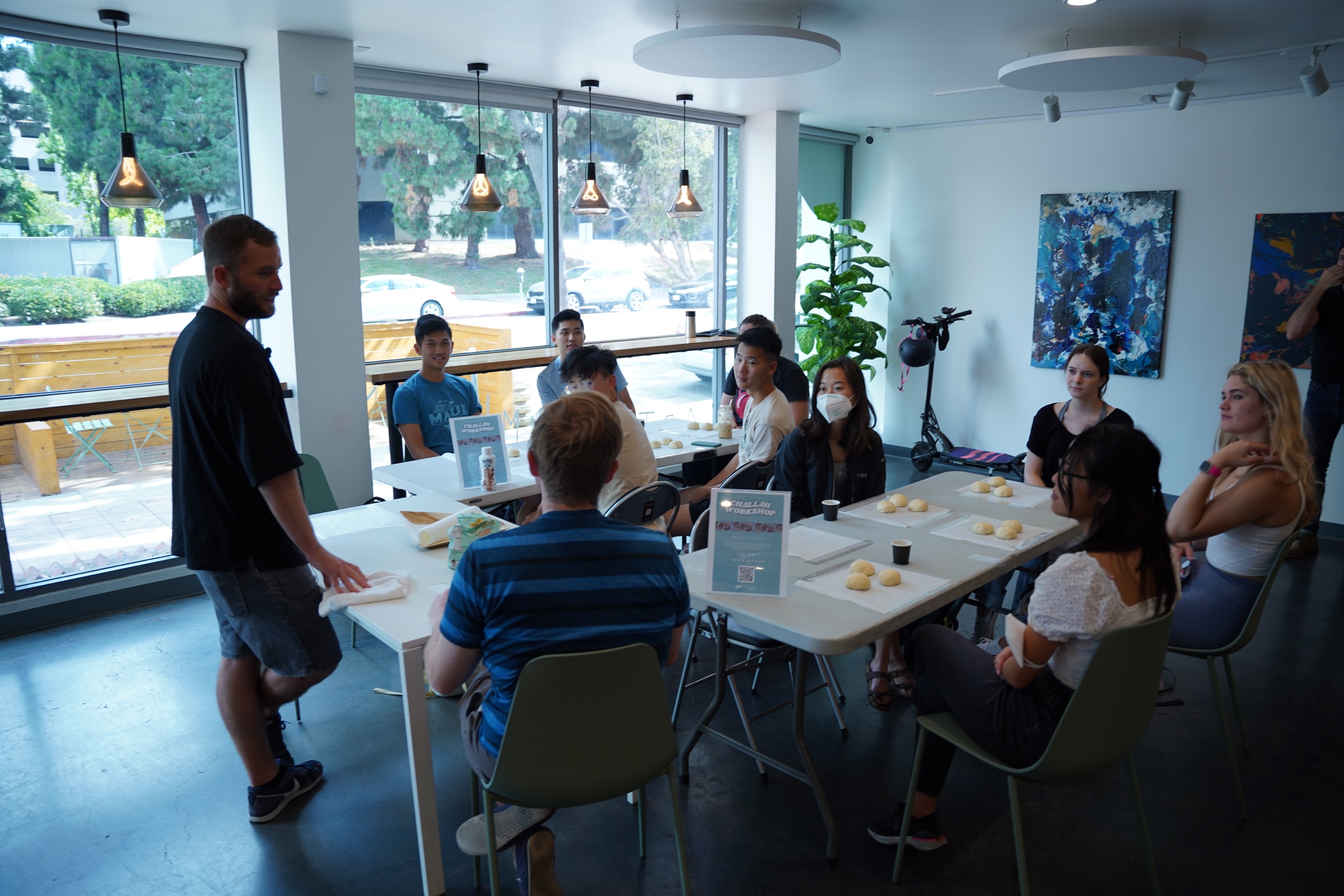 Chaim guiding participants during a hands-on challah workshop