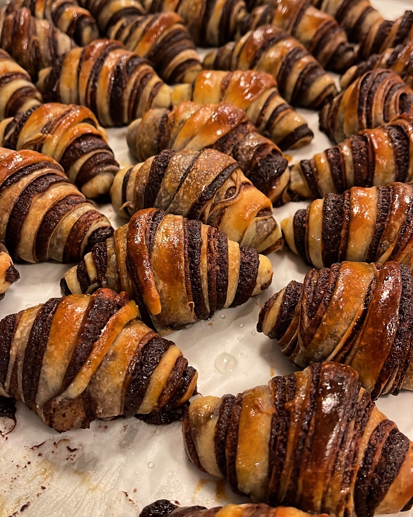 Freshly baked chocolate rugelach with glossy golden pastry