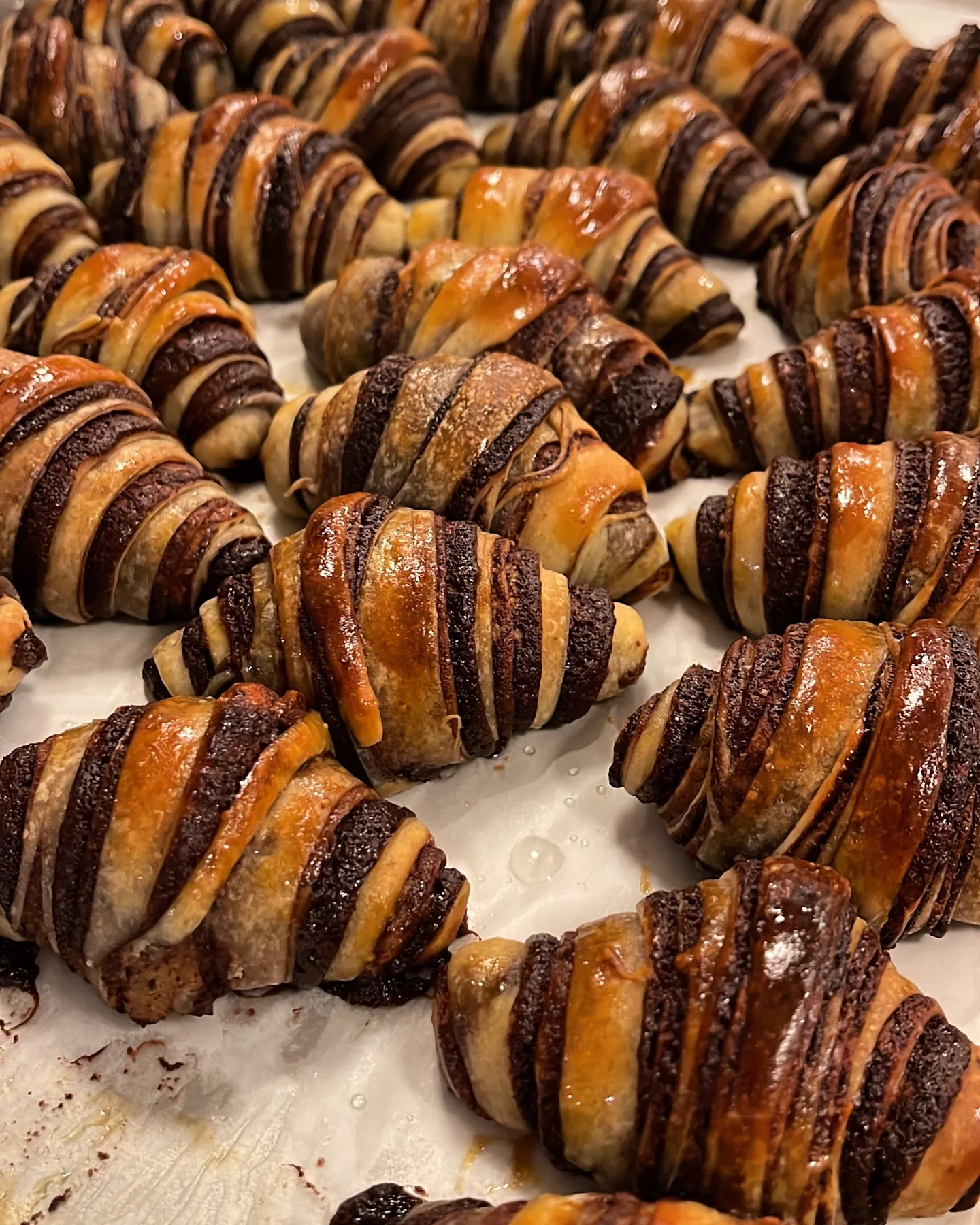 Freshly baked chocolate rugelach with glossy golden pastry